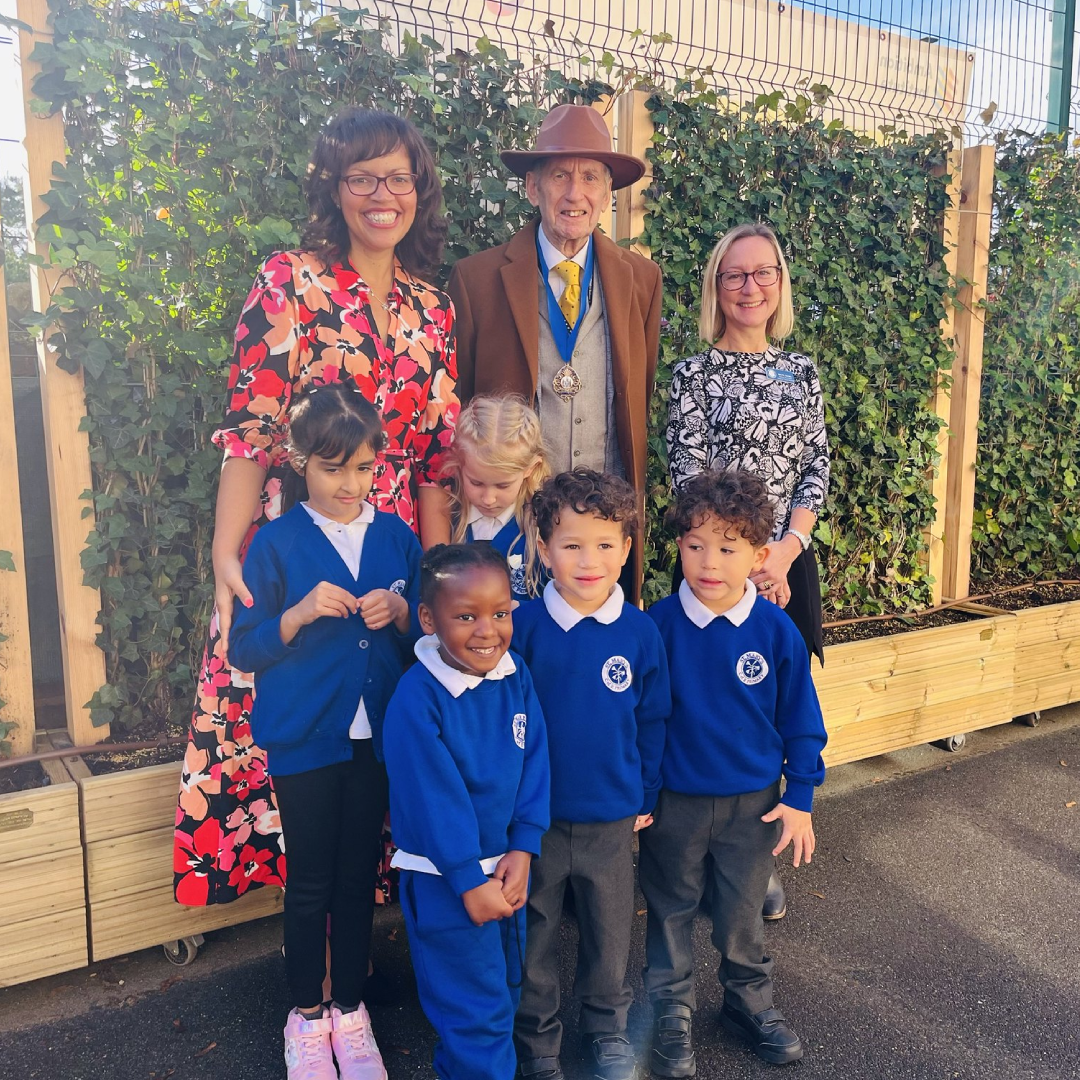 Pupils of St Mary's Infant school, the head teachers and Southend's deputy mayor stands in front of the newly installed living green wall