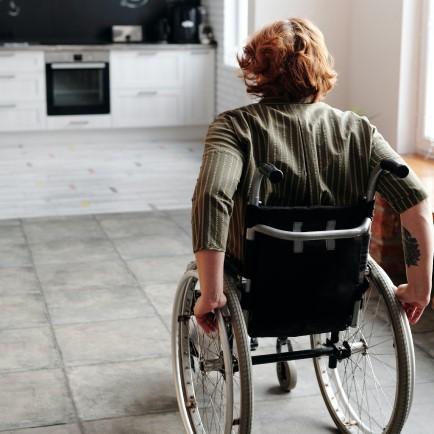 Person is in a wheelchair going in to their kitchen