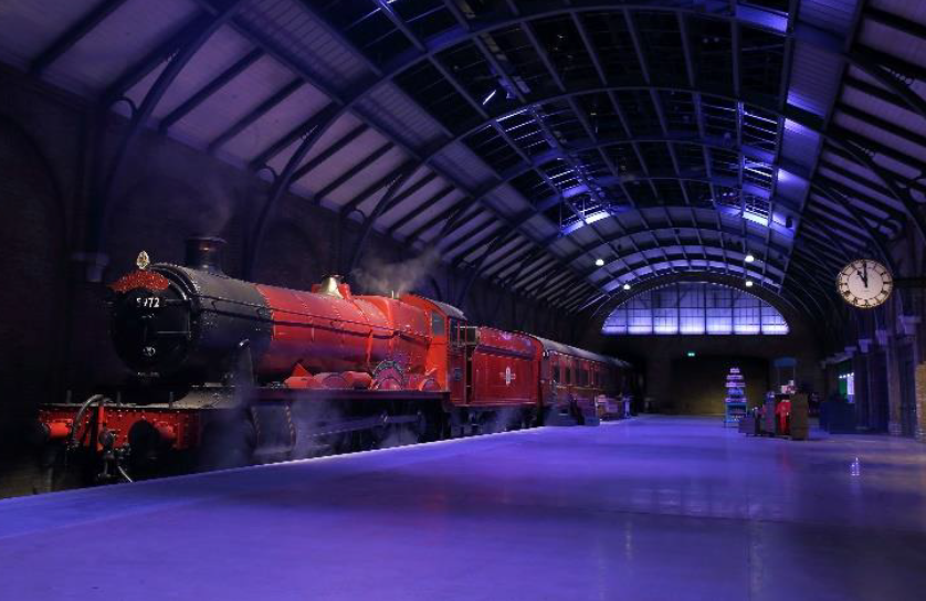 The Hogwarts Express at Platform 9 ¾. The steam engine train is ready to depart from the station.