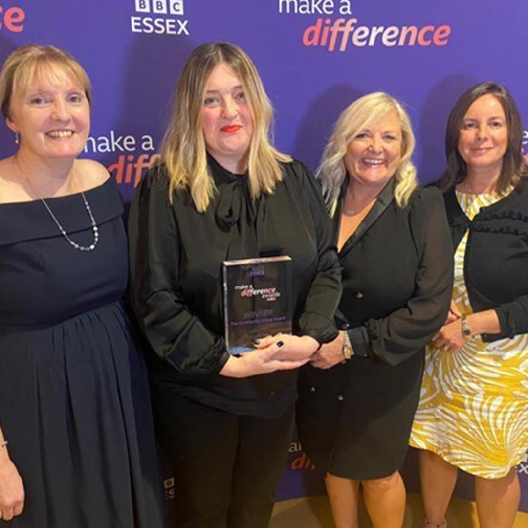 Four female representatives from Safe Steps photographed with the award at the Make a Difference Award ceremony