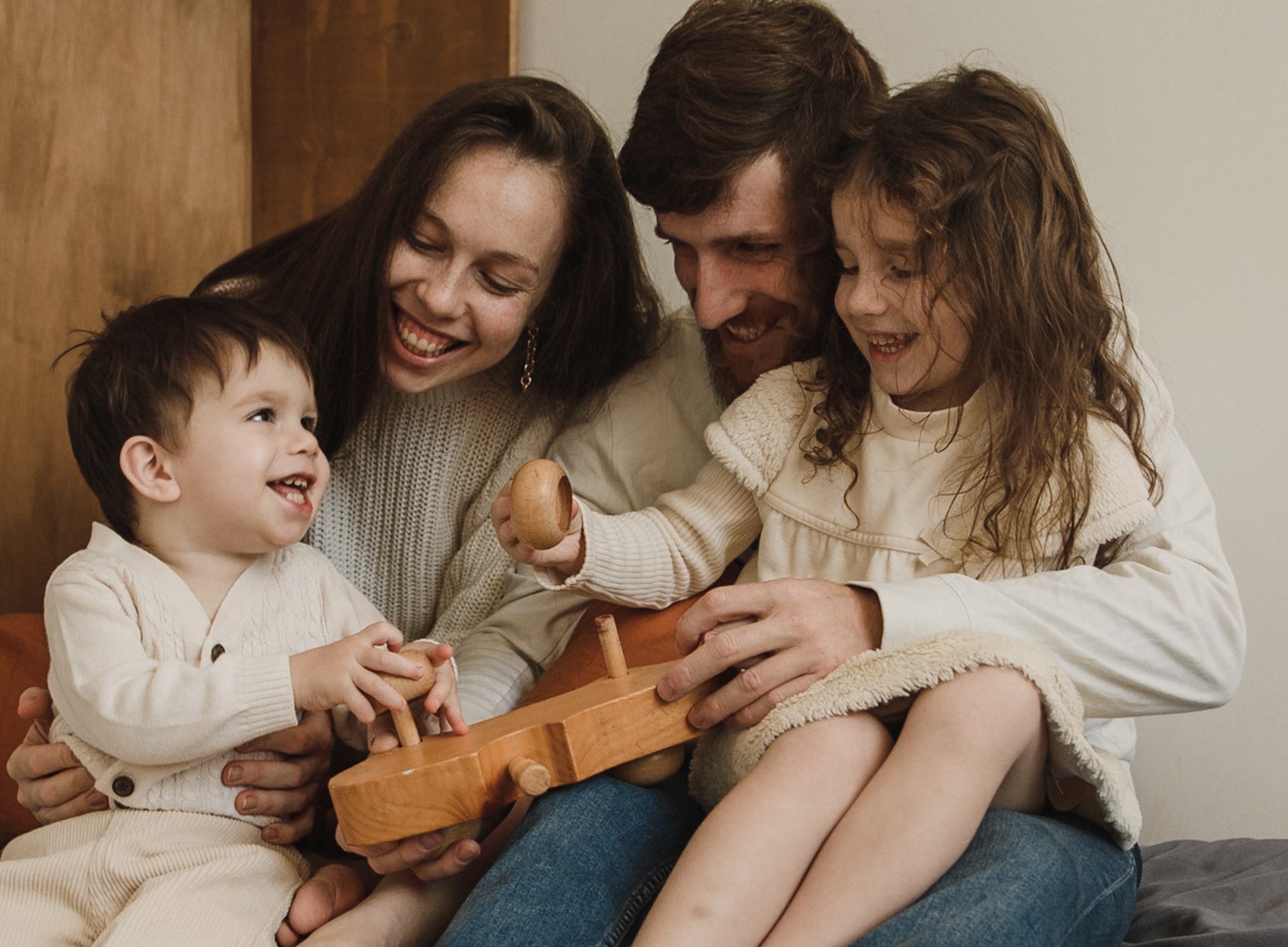 Parents playing with their children smiling