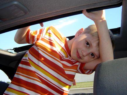 Young boy smiling at camera in a vehicle